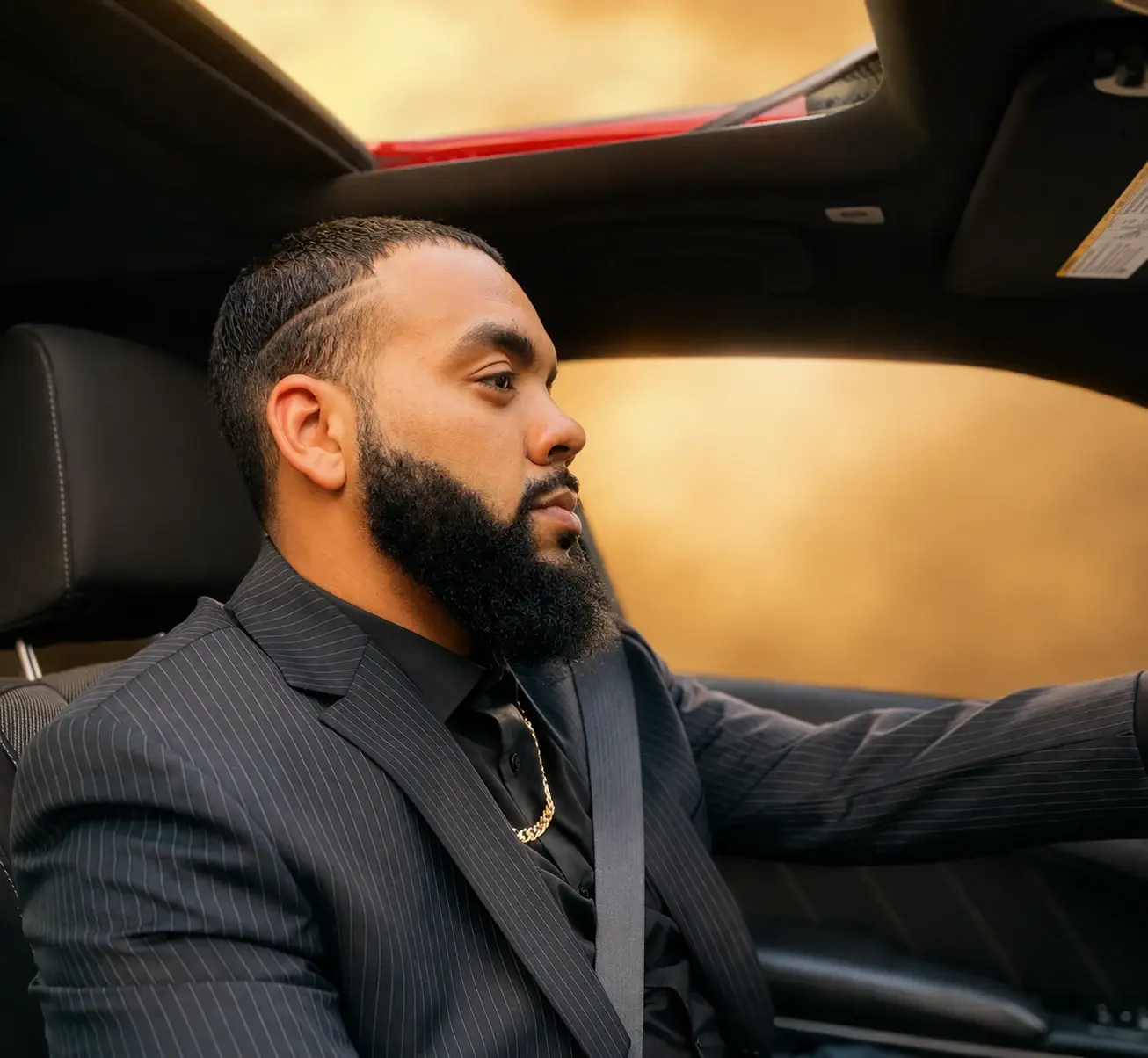 Concrete Motivation founder Jaytee Miller in a black pinstripe suit