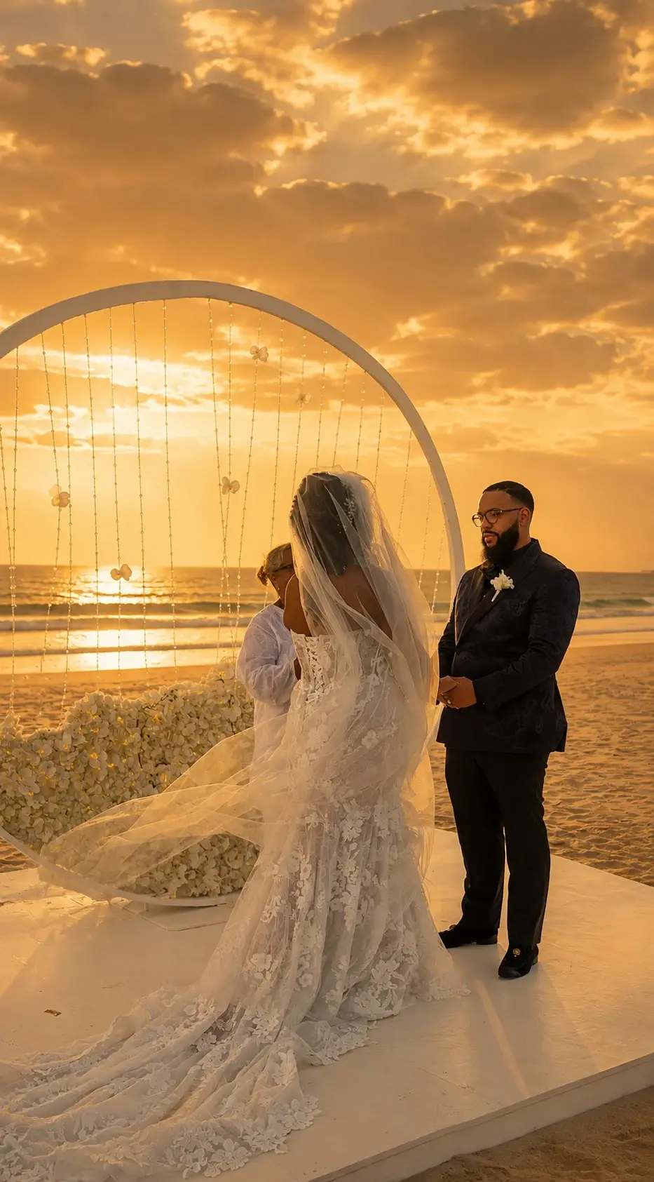 A bride and groom at their beach ceremony