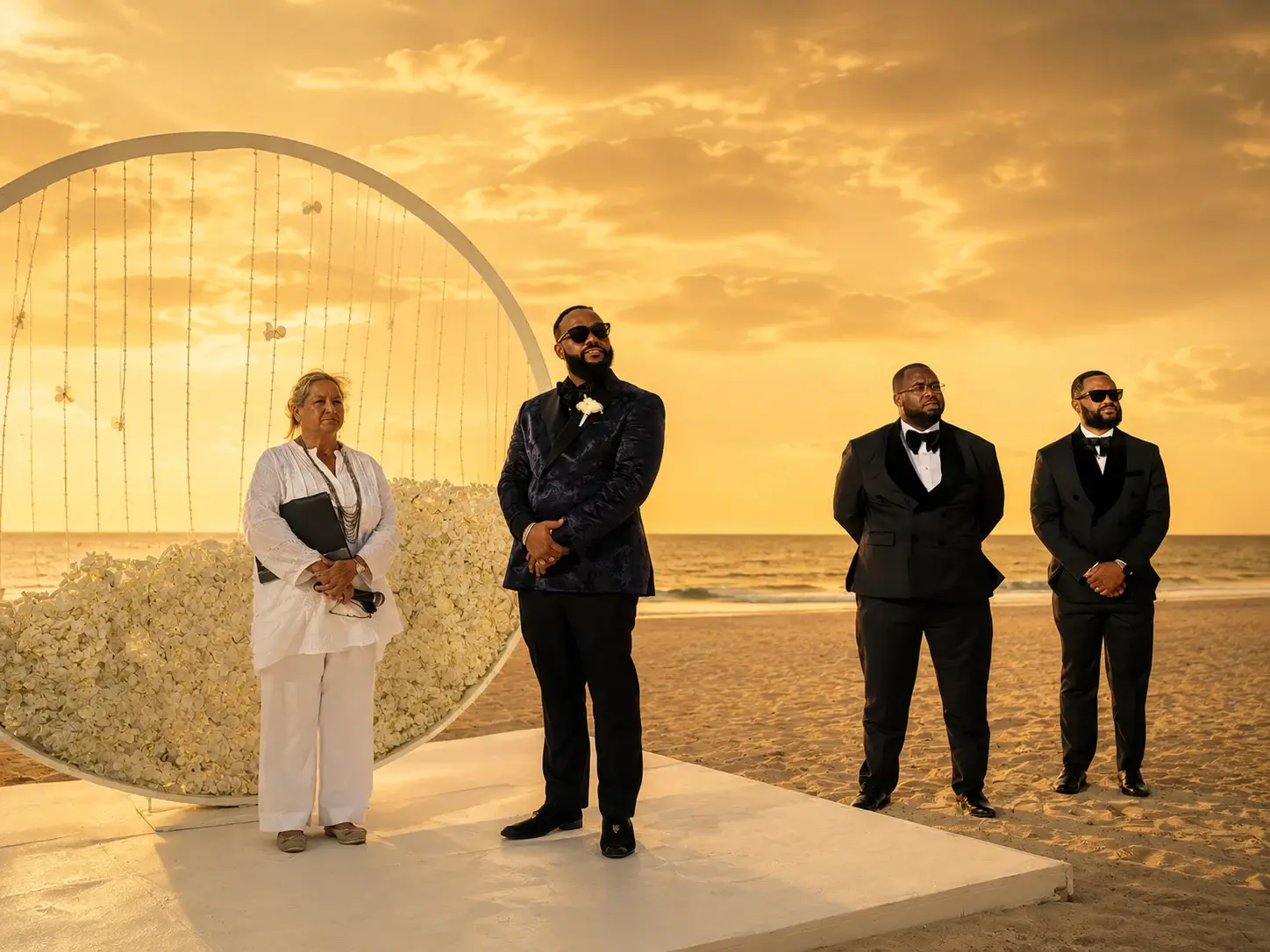 Men standing together at a beach wedding
